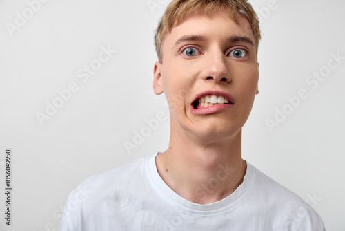 Photos Silly face close up of a man making a goofy expression, wide eyes and stretched