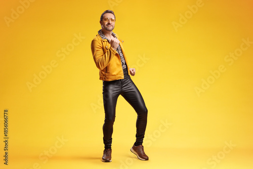 Fotografija Stylish man in retro disco outfit dancing