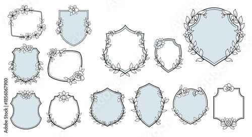 Set of various heraldic shield shapes decorated with delicate hand drawn floral wreaths and botanical elements in light blue and black.