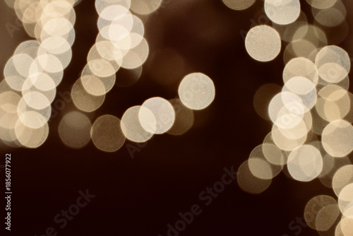 Abstract horizontal background with warm golden bokeh light orbs.