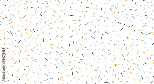Vibrant background of colorful short lines and dots resembling sprinkles or confetti scattered randomly on a clean white surface for party themes.