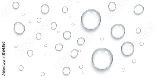 Clear transparent water droplets of various sizes scattered on a clean white surface