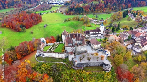 Gruyeres Castle and autumn forest aerial panorama view. Gruyeres, Canton of Fribourg, Switzerland.