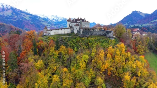 Gruyeres Castle and autumn forest aerial panorama view. Gruyeres, Canton of Fribourg, Switzerland.