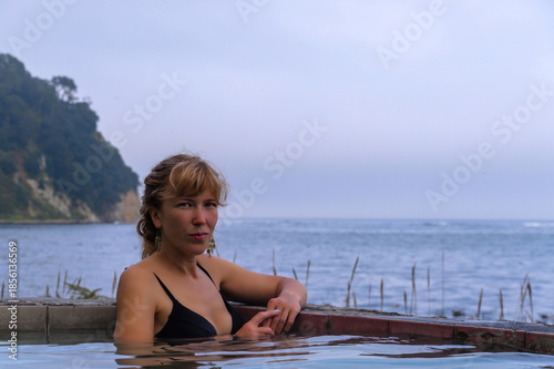 Relaxing in a warm pool by the sea on a calm afternoon in Russia