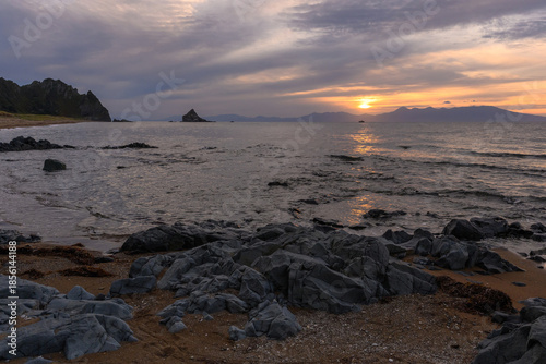Sunset over rocky coastline in Russia creates a serene atmosphere at dusk