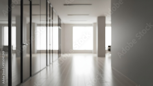 Blurred office hallway with glass walls and neutral colors creates a sense of space. Professional photos for backgrounds for text, banners, posters, and web displays. High quality