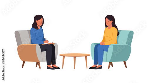 Professional female therapist actively taking notes while her client speaks, sitting across a small table in a comfortable setting.