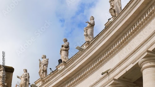marble statues walls vatican city saint peter’s basilica stand clear elevated line their placement adds detail upper exterior to top wallline row sacred figures 