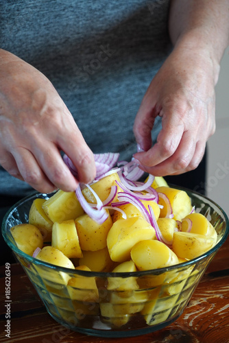 A woman prepares a delicious fresh potato salad