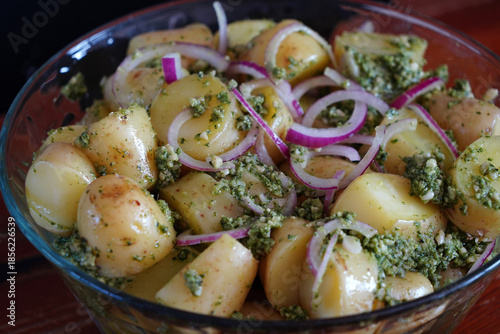 A woman prepares a delicious fresh potato salad