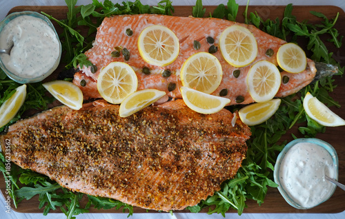 Delicious fresh salmon prepared on a platter with lemon and salad