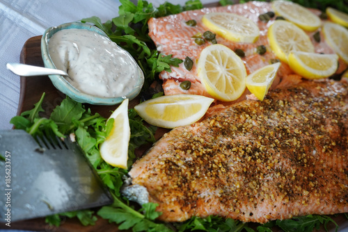 Delicious fresh salmon prepared on a platter with lemon and salad