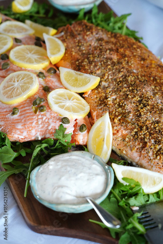 Delicious fresh salmon prepared on a platter with lemon and salad