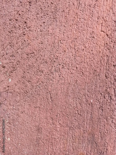 the wall is made of red concrete