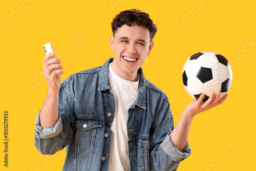 Happy young man with mobile...