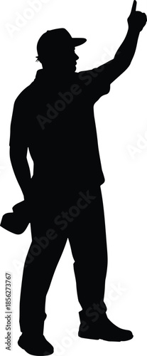 Silhouette of a professional photographer or filmmaker wearing a cap, holding a camera, pointing upwards towards the sky for a creative photo shoot