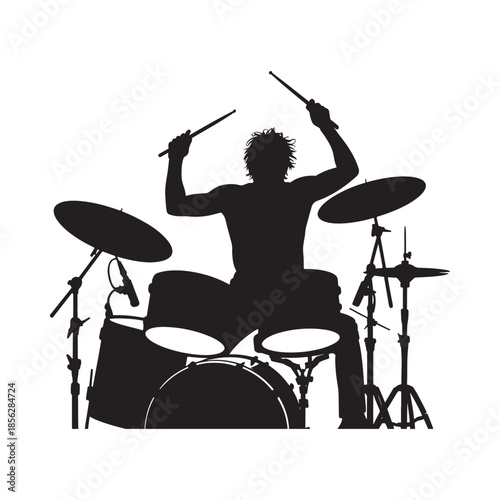 A silhouetted drummer passionately playing his drum set with raised sticks showcasing energetic musical performance