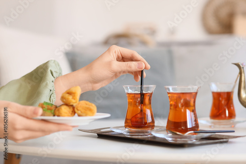 Young woman with glasses of...