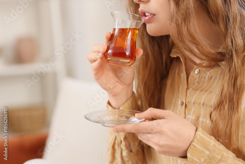 Beautiful young woman drink...