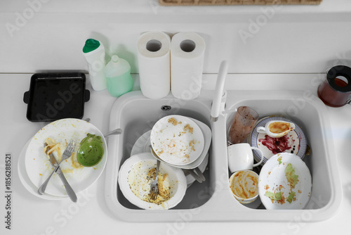 Heap of dirty dishes in sin...
