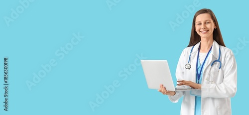 Female doctor holding lapto...
