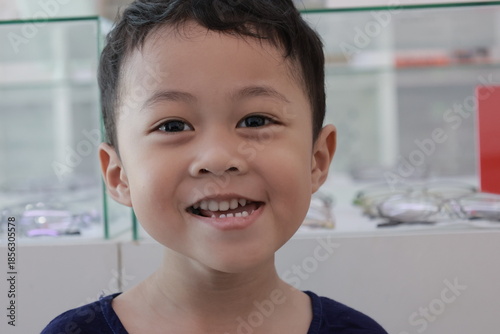 Portrait of a children in a park, A 3-year-old boy is happily walking in the park, wearing an Asian-style blue and white shirt.