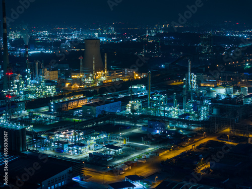 Aerial Night View of Glowing Industrial Complex with Pipelines