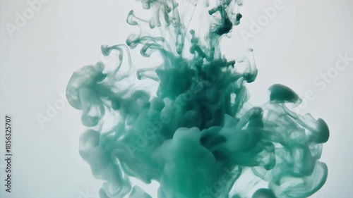Teal green ink spreading in water abstract movement