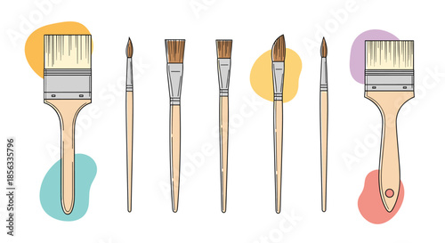Set of various artist paint brushes for painting and drawing, with wooden handles and different shapes, on a background with colorful spots.