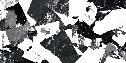 Abstract black and white fractured surface with sharp angular shapes and contrasting light highlights creating a textured design