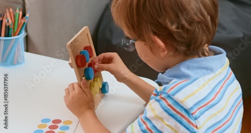 Child Engaging in Creative Play with Colorful Educational Toy