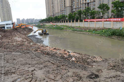 Canvastavla Excavators Dredging River in Urban Construction Project