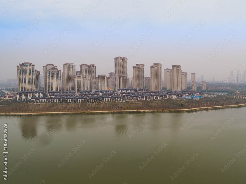 Obraz premium Chutian Residential Waterfront Aerial View with Modern High-Rise Development