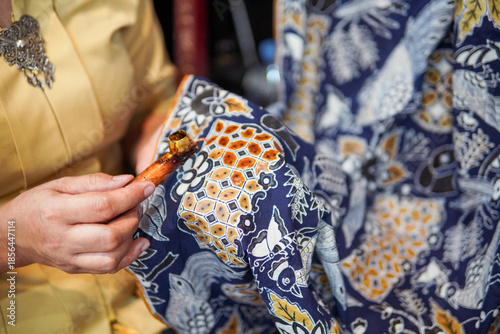 Woman Creating Traditional Batik Textile Using Hot Wax and Canting in Indonesia