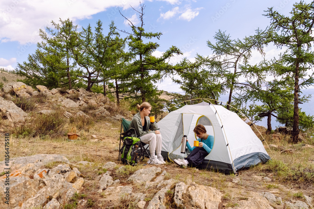 Fototapeta premium Enjoying a peaceful camping experience with friends in a beautiful natural setting