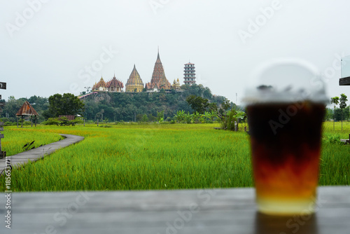 Kanchanaburi, Thailand,  December 5, 2025 : View of green field and Tiger cave temple from Meena cafe.