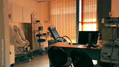 Gynecologist examination room interior with medical chair and equipment