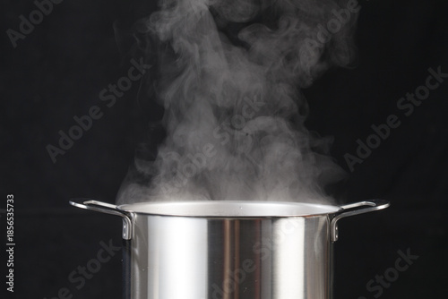 Billede på lærred Modern Shiny Stainless Steel Pot with Boiling Water and Steam