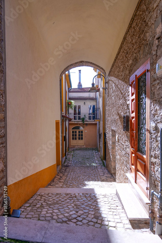 A narrow street among the old houses of Capriati a Volturno, a small town in the province of Caserta, Italy.