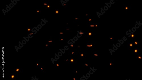 Flying fire embers and glowing sparks floating on a black background for visual effects overlay