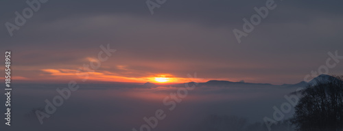 Winter sunset with inversion fog from valleys in Nemci village