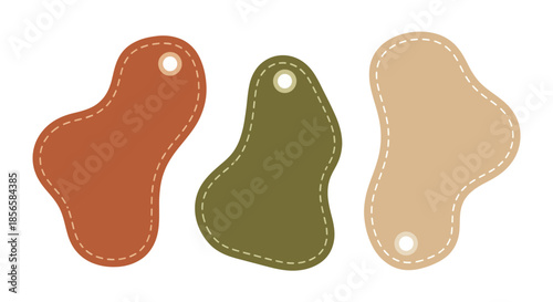 Three abstract, organic-shaped tags with stitched edges and a hole punched at the top, in shades of brown, green, and beige.