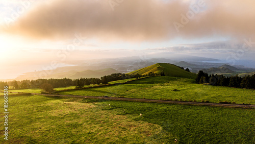 Sunset over green pastures, Azores islands, drone view.