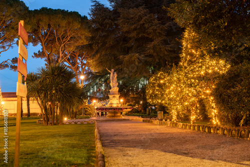 Park fountain surrounded by illuminated trees and holiday decorations during the Christmas season in Opatija, Croatia