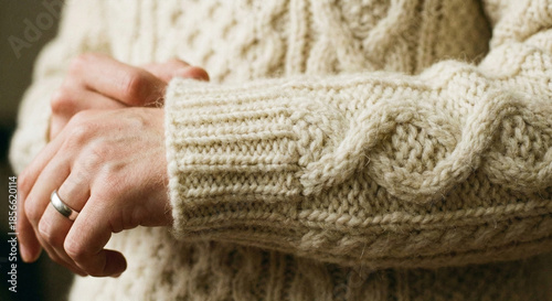 Close-up of Hands in Cozy Cream Cable Knit Sweater for Winter Fashion