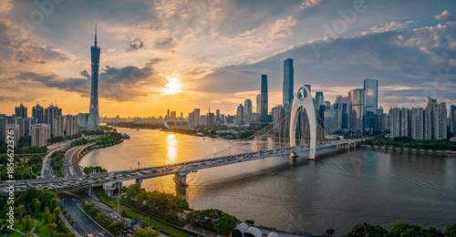 Fotografie Aerial view of the modern city skyline with bridge at sunset in Guangzhou, China
