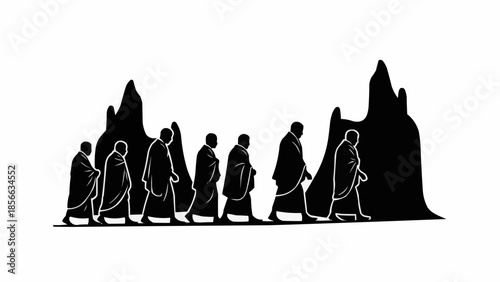 Monks walking in a line with mountains behind them.