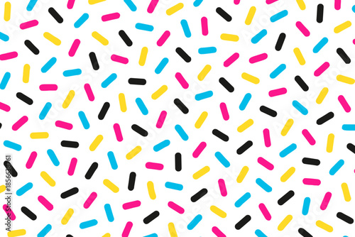 Colorful sprinkles scattered on a white background in a random pattern throughout the space