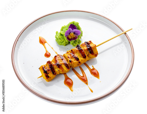 Delicious Chicken Satay Skewers with Peanut Sauce and Garnish.